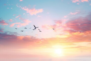 Fototapeta premium A serene image depicting birds in flight against a softly colored sunset sky, evoking peace and freedom.