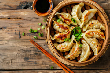 Top view fresh dumplings with hot steams on wood plate with chopsticks, chinese meal. Rustic old vintage wooden background, copy space