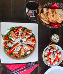 Salmon salad served on table with a glass of wine