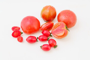 Various fresh tomatoes on white background
