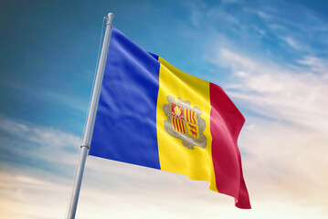 Waving flag of Andorra in blue sky. Andorra flag for independence day. The symbol of the state on wavy fabric.