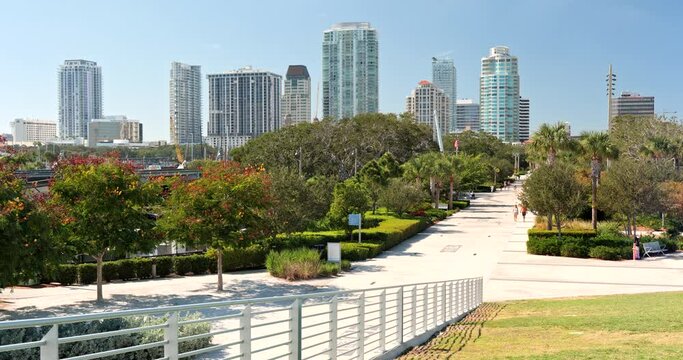 People walk on the St. Petersburg city coastal waterfront St. Pete Pier boardwalk path on Florida's Gulf Coast