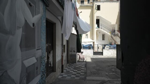 Naples, Italy - May 7, 2023: a street in the old historic center of Naples, Italy. Naples, center of city old Spanish quarter street with famous landmark, touristic attraction street art