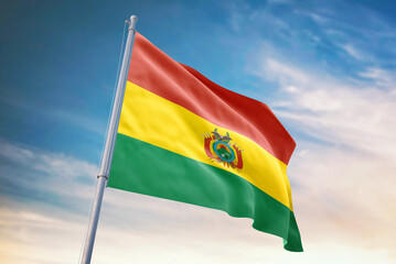 Waving flag of Bolivia in blue sky. Bolivia flag for independence day. The symbol of the state on wavy fabric.