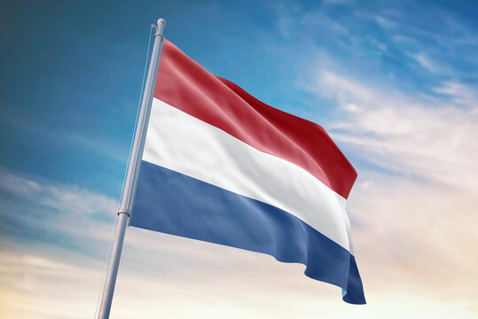 Waving flag of Netherlands in blue sky. Netherlands flag for independence day. The symbol of the state on wavy fabric.