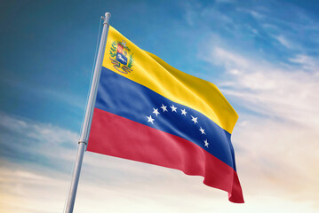 Waving flag of Venezuela in blue sky. Venezuela flag for independence day. The symbol of the state on wavy fabric.