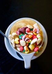 Cereal on latte, coffee art, nostalgic beverage, cafe drinks, colourful beverage, whimsical, lucky charms