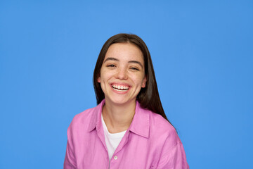 Smiling pretty freckled gen z brunette Latin girl, cute happy Hispanic teen student wearing pink shirt looking at camera laughing standing isolated on blue background. Close up portrait. - obrazy, fototapety, plakaty