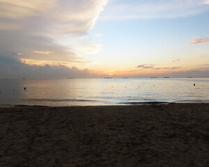 landscape on the Caribbean coast of Colombia with a beautiful sunset adorned with palm trees, beach, sand, sky of multiple colors