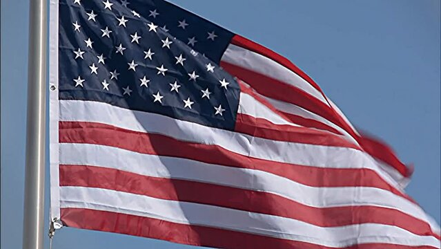American Flag flying in strong breeze on sunny day