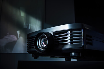 Close-up of modern projector displaying image with ambient lighting