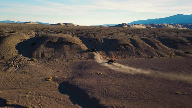 Side By Side UTVs racing in the desert canyon