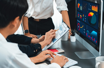 Data analysts team working analyzing business intelligence BI dashboard display on laptop to...