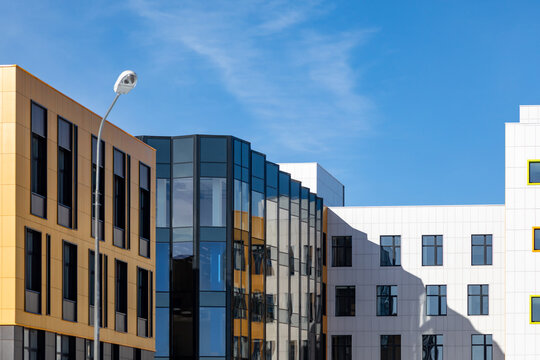 Fragment of urban neighbourhood with low-rise office buildings, commercial real estate of typical design.