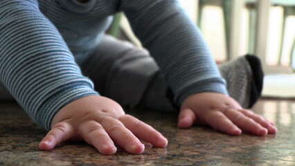 Obraz na płótnie Canvas Cute baby boy hands closeup on floor