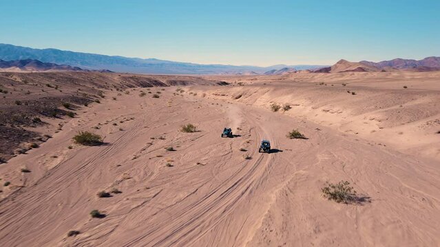 Side By Side UTVs Racing through the Desert Canyon