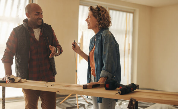 Mature couple working as a team in renovating their house