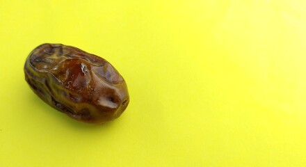 Dates fruit on a yellow background with copy space for text.