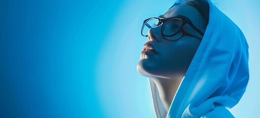 Profile view of young beautiful white girl in hoodie posing isolated on gradient blue-white background in neon - Generative AI