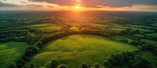 Aerial view of endless lush pastures and farmlands - obrazy, fototapety, plakaty