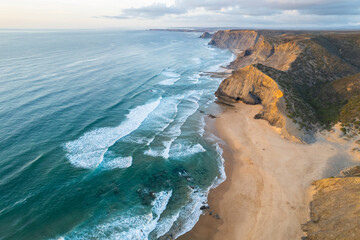 Sunset over amazing Cordoama sandy beach in Portugal. Aerial drone view