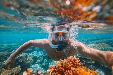 Foto auf Alu-Dibond Snorkeler dives amidst vibrant coral reefs in clear blue waters, showcasing marine exploration © Татьяна Евдокимова