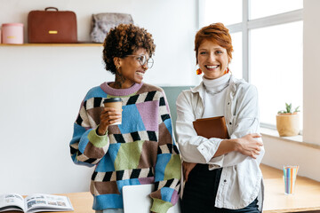 Colleagues in cozy co-working space enjoying coffee break