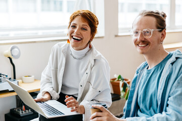 Smiling colleagues working together in a bright co-working space