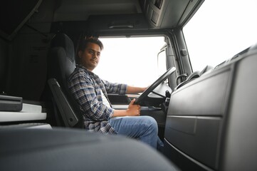 Portrait of a young handsome Indian truck driver. The concept of logistics and freight...