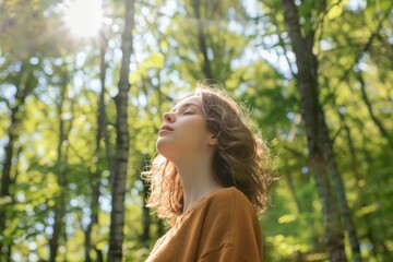 Naklejka premium A young, relaxed woman immersed in a serene green forest, enjoying the refreshing air and warm sunlight