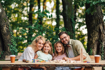 Happy family hugging and spending time in nature together.