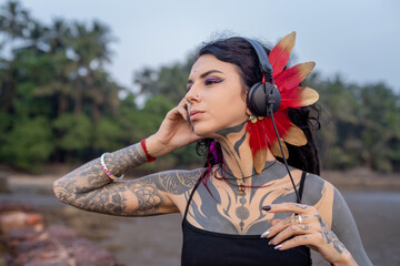 a woman with tattoos is wearing headphones and a flower in her hair