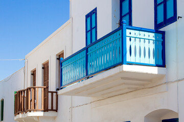 Traditional architecture of Greek islands, with wooden balconies painted in bright colors, alongside with the windows. Here as in Nisyros island, Dodecanese, Greece 