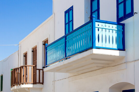 Traditional architecture of Greek islands, with wooden balconies painted in bright colors, alongside with the windows. Here as in Nisyros island, Dodecanese, Greece 
