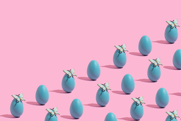 Pattern with Easter eggs and butterflies on a pink background. Holiday concept.