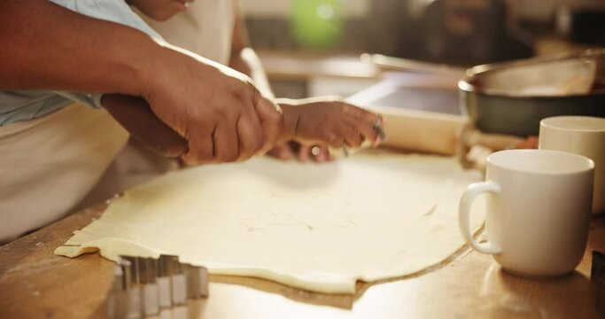 Hand, child and mother with closeup for baking in kitchen with cookie cutter, healthy development and learning. Family, person and kid with cooking for bonding, teaching and support together in home