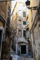 Fototapeta na wymiar A residential area of narrow alleys, tunnels and stairs in the hillside district La Pigna di Sanremo, the medieval old town of the coastal city of Sanremo, Italy.