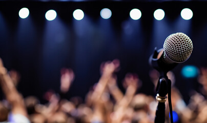 Microphone on Stage with Lights and Crowd in Background with Copy Space