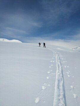 Ski tour through the fresh powder snow. Traces through the deep snow in the mountains of Davos Klosters Mountains. Skitour  in Switzerland. High quality photo