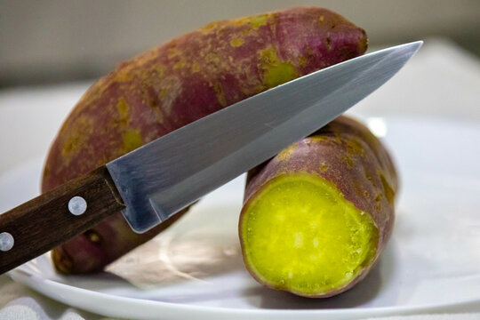 Sweet potato (Ipomoea potatoes) cooked whole and cut in half isolated and in selective focus