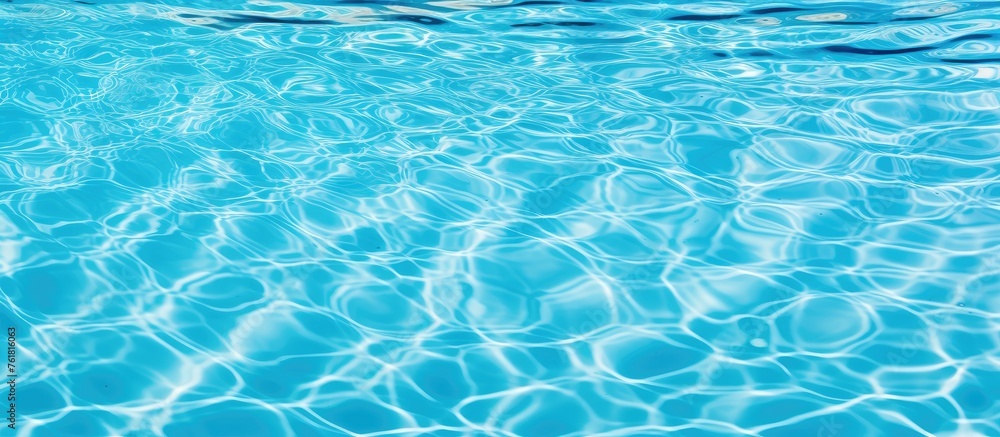 Poster a close up of the liquid in a swimming pool shows a mesmerizing pattern of azure waves, creating an 