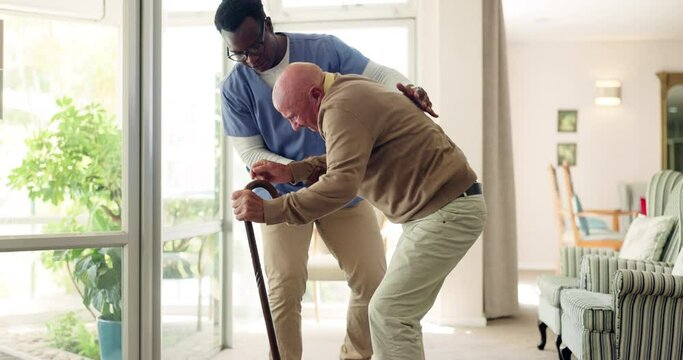 Senior, man and nurse for help with falling with walking stick, medical support and assisted living. Elderly, patient or professional caregiver with assistance, compassion or vertigo on floor of home