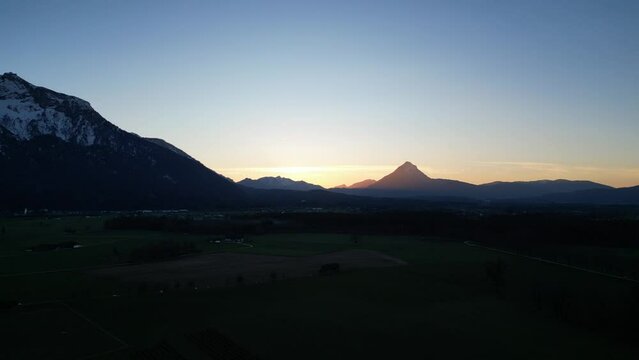 Scenic drone footage of the snowcapped Untersberg Mountain in Salzburg, Austria. Shot via drone in 4k at both sunrise and sunset. Along with the small town at the bottom of the mountain.