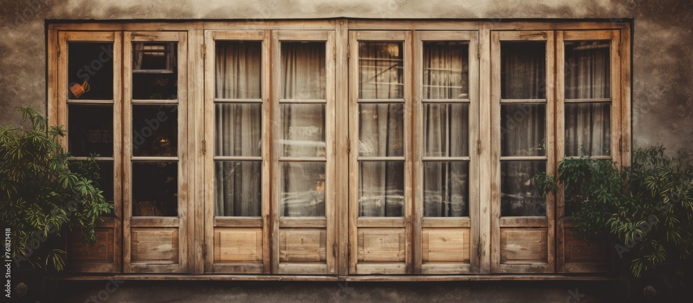 Poster the buildings facade features a large wooden window with multiple rectangular panes, adding symmetry