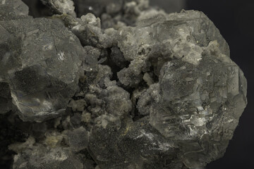 Macro shot of translucent fluorite crystals displaying cubic structure on dark background