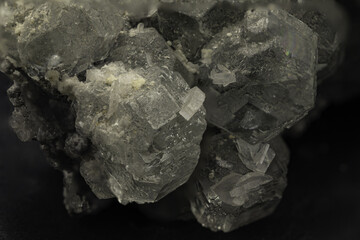 Macro shot of translucent fluorite crystals displaying cubic structure on dark background