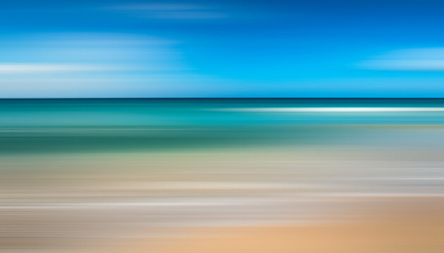 A motion blurry image of a beach with a blue sky in the background. The water is calm and the sky is clear,  abstract tropical seascape, sea with waves of sand and blue sky with white clouds