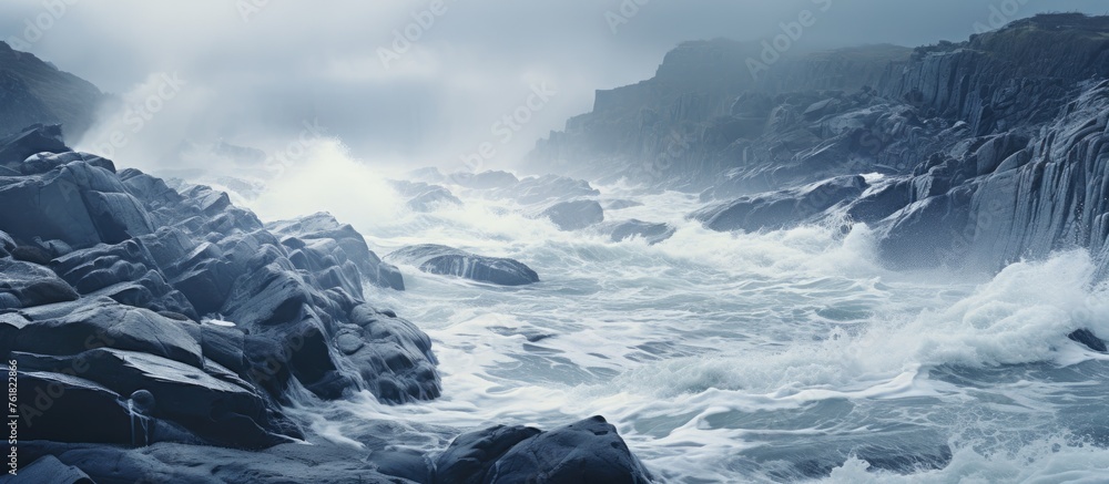 Poster water flows through the river with waves crashing against the rocks under a cloudy sky, creating a d
