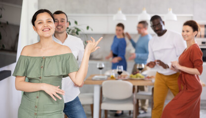 Fototapeta premium Modern dances performed by men and women of different nationalities at a holiday party at home