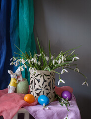 A still life arrangement of Easter eggs, spring flowers. Still life with snowdrops and ester eags. - 761823455